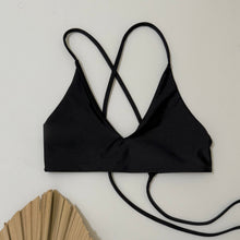 Load image into Gallery viewer, Black bikini top with crisscross straps on a white background