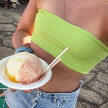 Load image into Gallery viewer, Person wearing a green bikini top and denim shorts holding a snow cone.