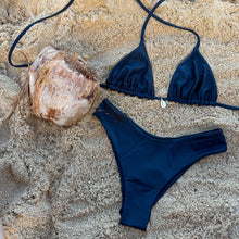 Load image into Gallery viewer, Black bikini set on sand with a coconut nearby